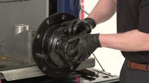 A man installing a Guardian HP Wheel Seal