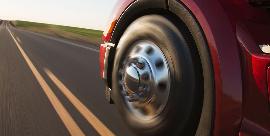 Close up of a wheel on a semi going down a road