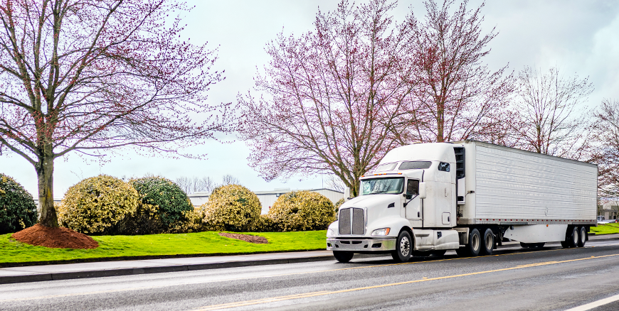 Semi driving down a road