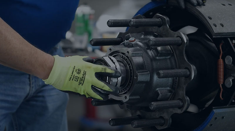 Someone putting together a Trifecta Pre-Adjusted Hub Assembly