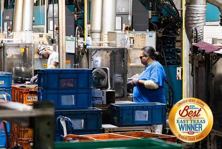 Image of two employees working on a factory floor surrounded by pipes and boxes. The Best of East Texas Winner 2025 logo is overlayed in the bottom right corner.